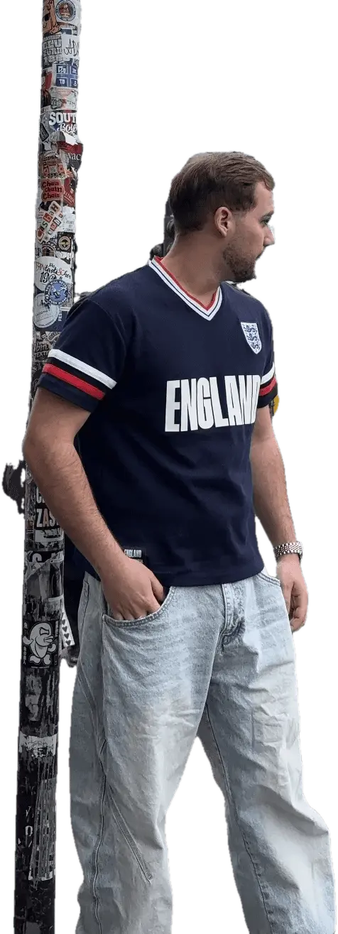 Valentín Durán Werneke in Camden, London, in an England shirt, next to a lamp post covered in stickers.